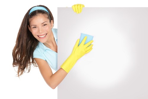 Cleaner maintaining a kitchen in Barnes during a routine visit